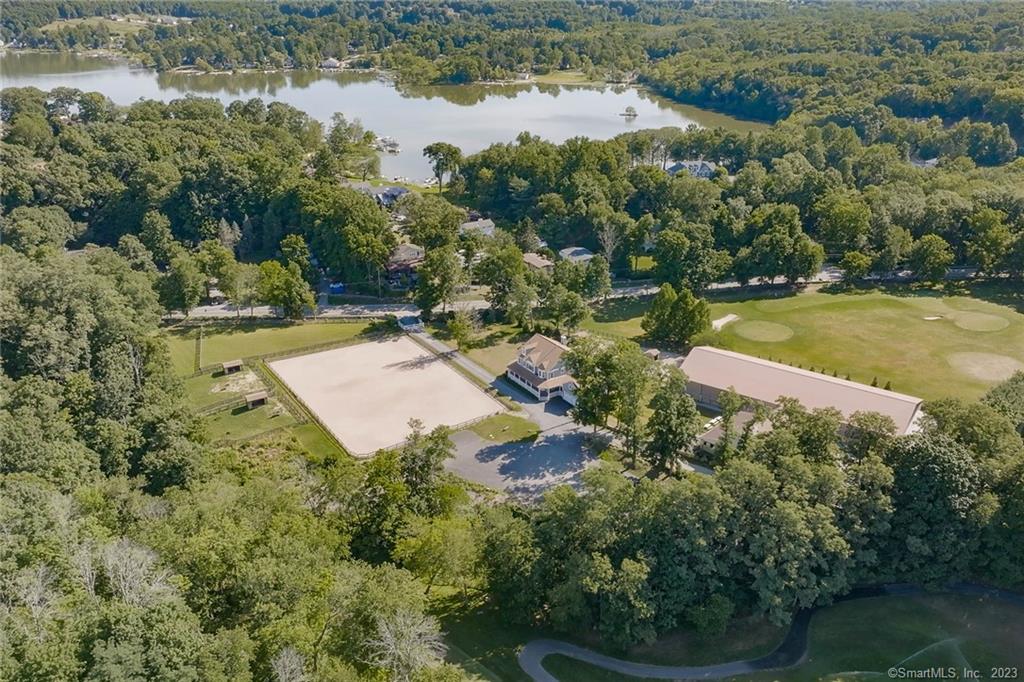 This pastoral manor, known as Summit Farm, is one of North Salem's premier equestrian estates located on 4+ acres having direct access to the historic North Salem Bridle Trails. Summit Farm's signature is its superb equine facilities for personal or commercial use. The main barn is the original charming farm building with 15 stalls, a cozy office, two grooming stalls, a wash stall, a large-heated tack room and powder room. There is a shed row barn with 4 stalls, while the back barn has 6 stalls, each having individual walkouts. The back barn opens into a sensational 70' X 170 heated indoor riding arena with GGT footing. Adjacent to Salem Country Club's legendary golf course, the estate offers 8 paddocks, 5 grass and 3 all-weather paddocks with 5 run-in sheds and a 130'x220' outdoor riding arena with irrigation and Lawton Adams footing, wood and electric fencing. The quintessence of modern country-luxe living, the residence is a beautiful custom-built colonial Farmhouse with a wraparound porch offering an open floor plan. You enter the foyer to a grand staircase which flows into an elegant living room with centuries-old hand-hewn beams from the original house. A beautiful corner office overlooks the outdoor arena and paddocks. The sunny Kingswood kitchen boasts a Wolfe range, Sub-Zero refrigerator, quartzite countertops and spacious island made of cherry wood. Located off the kitchen is an inviting family room with a wood-burning fireplace and an enchanting dining room with a