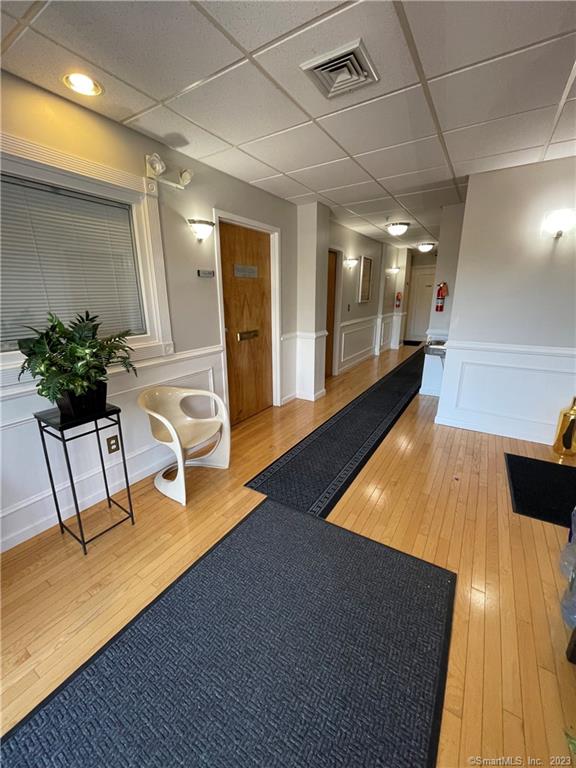 Modern professional office space in a desirable well maintained elevatored building. This 6-7 room unit is ideal for medical, wellness & professional services. Situated in a high traffic location with excellent visibility, this property is easily accessed from Routes 15 and 91. Pride in ownership of this brick construction building that has been completely updated and well maintained provides your client visitors with a warm welcoming environment throughout. Featuring newly installed luxury vinyl planks, updated lighting, spacious reception area with privacy glass, 5 modern private doored offices, an open space area that can accommodate a conference area or build out two additional offices, kitchenette area with sink and storage area. Freshly painted walls with modern gray/white decor. Private keyed bathroom. PLUS - your clients will have no trouble parking as there is a convenient parking lot that accommodates a total of 42 vehicles combined with handicap accessibility . Call today for a private showing. Additional square footage available if needed. See MLS# 170544816.