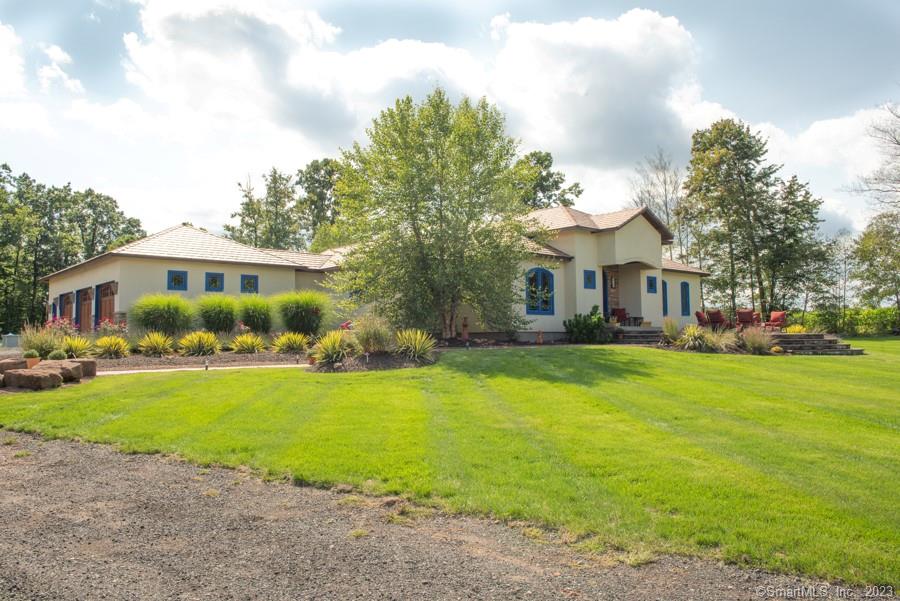 Spectacular 3 bedroom 2 1/2 bath ranch set on a private 6.10 acre retreat with geothermal heating (no worry about oil prices!). The attention to detail in this stunning home is evident from the moment you walk up the custom walkway to the large front patio with recessed fire pit. The open floor plan is perfect for entertaining, beginning in the spectacular kitchen featuring Thermador commercial appliances (separate refrigerator and freezer), huge island, bar area with wine/beverage refrigerator, hickory cabinets, pot filler and hand painted Talavera tiles. The great room and dining room offer 13 ft ceilings, propane fireplace and french doors out to the covered deck area. The primary suite is the perfect place to end your day with 10 ft tray ceiling, 6 ft transom over the bed, propane fireplace, large walk-in closet and gorgeous bathroom with large walk-in tiled shower (with rain head, wand, 4 body jets) and double vanities with hand hammered copper sinks. There are 2 additional nice size bedrooms with a Jack and Jill bathroom. The utility wing features a guest bathroom, separate laundry room, walk-in pantry and access to the oversized 3 car garage. Once outside relax on the front patio with the incredible view or enjoy the covered deck area , the bocce ball court or pool area.