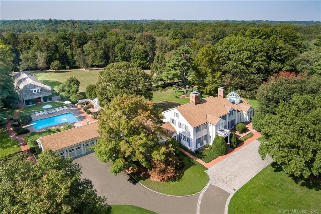 Poised on over five majestic acres in the heart of Greenfield Hill, this spectacular family compound enjoys unmatched privacy, minutes from shopping and dining. Being sold AS IS and already gutted/prepped for future renovation, the main house with an English conservatory offers the opportunity to restore this breathtaking home or build your dream. Resort amenities include a swimming pool surrounded by a brick terrace, pool cabana, lighted tennis court, and three-stall tennis barn. The award-winning fieldhouse consists of a main level sitting area, a replica of the Mohawk Mountain swing, a regulation racquetball court, gymnasium, changing rooms with two showers and a shared half bath, and a loft perfect for game nights. An arbor and beautiful lit fountain offer an enchanting place to relax in the shade and enjoy the serene landscape. If you are interested in a larger estate, please inquire with the listing agent, for details about additional adjacent properties.