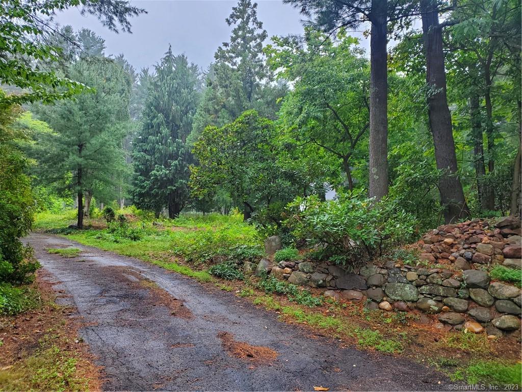 Rare and remarkable! This 3+ acre lot offers complete privacy yet less than 10 minutes to all amenities. Park like, a natural palette of stately deciduous and evergreen trees where you can carve out the niche for your new home. Beautiful stone wall entrance. City sewer and natural gas available. This is an opportunity to build a dream home, maybe that contemporary farmhouse, plenty of space for out buildings, inground pool. You could have a 20-minute commute to Hartford, 25 minutes to Bradley International Airport. Top tier public and private schools within a short driving distance.Please note:The lot will be sold subject to a deed restriction prohibiting further subdivision and restricting its use to one single family home.PLEASE DO NOT ENTER THE PROPERTY UNATTENDED, WITHOUT AN APPOINTMENT