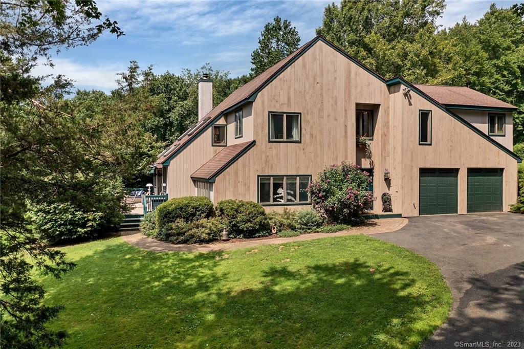 This 4 bedroom modern saltbox is surrounded by 3.25 acres of lush lawn and mature trees. Located on historic River Road, walking distance to Shepaug River, River Road Preserve, Roxbury Land Trust, hiking, swimming and fishing. The open floor plan offers multiple living and dining areas, a library with walls of built in bookcases, remodeled half bath and a sunken living room. The bright, kitchen with granite counters, and tile floor is open to a keeping room or music room with wood burning fireplace. The second-floor primary bedroom suite has vaulted ceiling and a Juliet balcony overlooks the side yard and patio. The additional three bedrooms include one en-suite and a 3rd full bath for guests.  The back yard is perfect to install your own pool if desired. Enjoy all Roxbury has to offer. A lovely home in a lovely location.