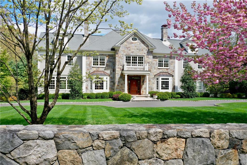 Welcome to this Gorgeous & Classic CT Colonial. The warm & welcoming foyer with stunning staircase opens to a private paneled office and sitting room, both complete with fireplaces. The living room with coffered ceiling, drenched in natural light with a fireplace leads to a gorgeous dining room with doors to an expansive deck. The perfect setting for all special occasions. The eat-in gourmet kitchen with high-end appliances offers a walk-in pantry, center island & plenty of counter space for the everyday chef. The show stopping family room with fireplace is surrounded by gorgeous windows & stunning views of the private property. Special features include 10 foot ceiling, primary suite with dressing room & fireplace, plus 4 en-suite bedrooms, finished lower level with fireplace, wine cellar, home theatre & gym. Extraordinary value for this exceptional home on 2.26 acres located on a quiet cul-de-sac just two miles to train & town center.