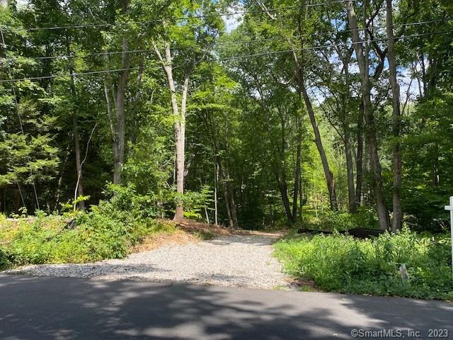 Beautiful very private high and dry building lot in an established neighborhood. Lightly wooded with house site situated 400' off road. Great in-town location, less than 10 minutes to UConn, easy access to highways, shopping, hospital, schools, etc. Gravel driveway has been installed, wetland crossings have been completed and house site cleared. Approved fora 4-bedroom non-engineered septic system. Great soils and good drainage.