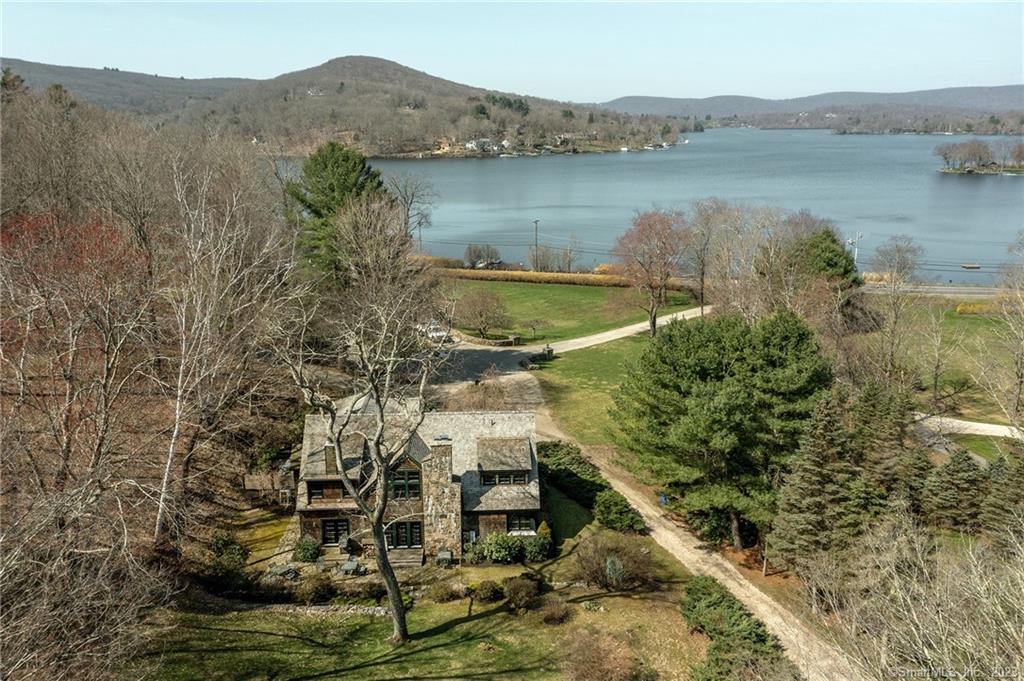 Lake Waramaug Carriage House. 7 bedrooms. 7 ? bathrooms. Eat-in country Kitchen. Living Room with fieldstone fireplace. Spectacular waterfront with floating dock and stunning western views. Rare.