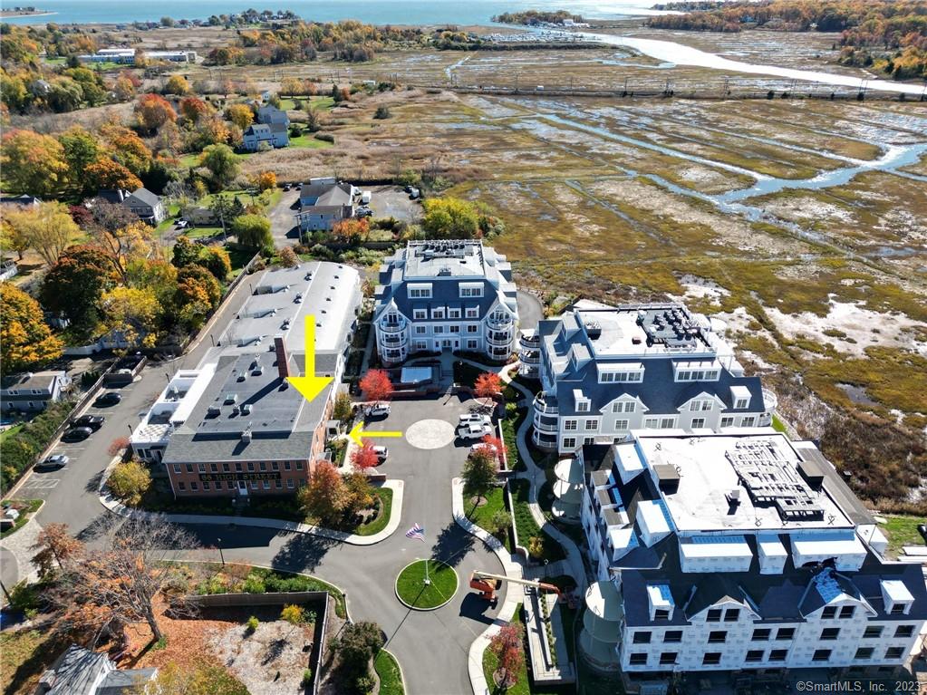 Enjoy this rare opportunity to experience luxury condo living combined with extensive town history just minutes from the beach on LI Sound. The Residences at 66 High Street are just a block from the train station, marina, Jacobs beach and the town center, where you can enjoy a plethora of choices for upscale dining, boutique shopping, or an evening walk around the green. Many details of the original Mill have been preserved and elegantly woven in with the current top of the line finishes and appliances to make for a sophisticated, yet warm and inviting space. Upon walking in you are greeted with beautiful hardwood floors, exposed brick and beams across the ceiling, along with a large gas fire place. The kitchen boasts a bright, open area containing top of the line appliances that make cooking dinner for the family a breeze. The half bathroom off of the kitchen encourages comfort and warmth with heated flooring. Up the stairs it's time to unwind and relax, with the first bedroom containing a full bathroom with heated flooring, and an abundance of closet space. The primary bedroom leads you to a full bath with heated flooring, a double sink and luxury shower, as well as a large walk in closet. Take advantage of all of the wonderful amenities that are included right in your own space as well, including the heated pool, full fitness room and cozy fire pit. You do not want to miss this opportunity at living in one of the most sought-after, award-winning complexes in Connecticut!