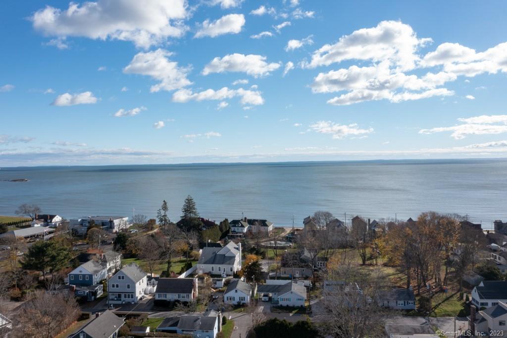 Deceivingly spacious and privately sited at the end of the road in a wonderful beach community - here is that turn-key home you've been looking for! Plenty of room for family and friends, this house was built in 2000 and has been lovingly maintained over the years. Stunning sunroom addition with walls of sliders to back deck and patio; beautiful dining room with fireplace, lovely kitchen and boasting that sought-after first floor bedroom and full bath. Upstairs find two more spacious bedrooms and third used as an office; pretty full bath with tub and stall shower - nice tile and finishes. There is a huge two bay tandem garage with summer kitchen, full basement and outdoor shed with power, plus outdoor shower with dressing room. Propane warm air furnace with central air ~ sunshine fills this home. Lovely level yard with paved drive, stamped concrete walk and pretty plantings. No flood insurance required! Eight minute walk to West Beach and/or a short hop to Westbrook Town Beach - beautiful! Westbrook town green, restaurants, shopping and Westbrook train station make this spot perfect for year round use or weekend escape. This property is being offered fully furnished and includes generator, riding mower, snow blower and all furnishings if so desired (Call for details). Just bring your toothbrush!