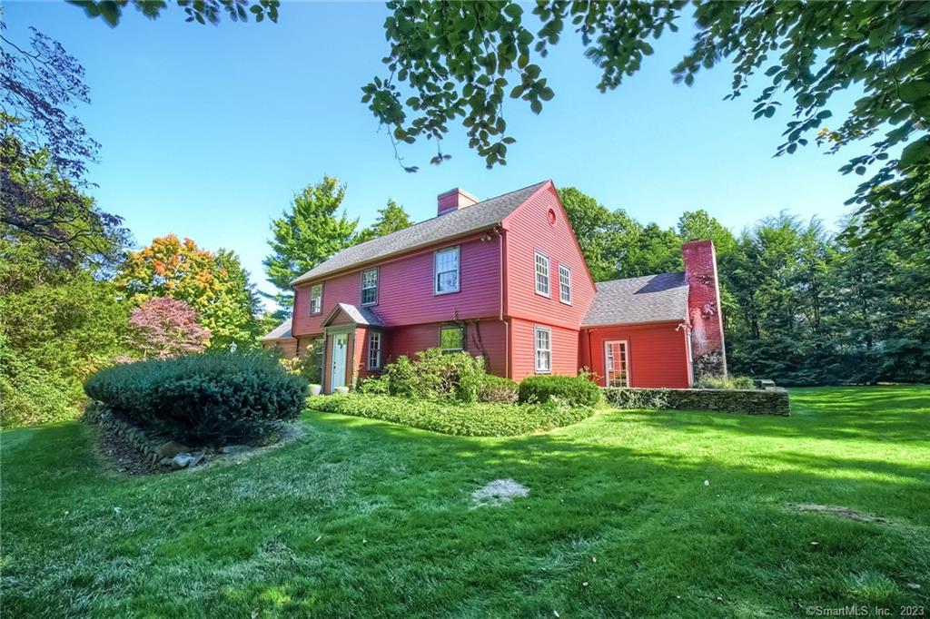 This charming colonial sits on a magnificent lot surrounded by mature trees and plantings, which make it feel like a tranquil secret paradise. Grace and character abound with lovely architectural details including HW floor, 3 fireplaces, crown molding, and classic millwork. Every room offers beautiful views and has lots of sunlight. The first floor offers a large front to back living room, a dining room with a picture window overlooking the walled bluestone patio and garden, and a heated sunroom with limestone walls, a fireplace, and two French door that lead to the yard. In addition, on this level there is a large kitchen with good workspace, a walk-in pantry, Viking stove, and Sub Zero refrigerator, a breakfast room, family room, and a primary suite with a dressing room, bath, small office, and fireplace. Two spacious bedrooms and full bath are on the second floor. The lower level has a finished room with a tile wine cellar with wet bar. The house has gas heat and hot water and central air conditioning. The outstanding location is a short distance to East Rock Park, Yale Campus, the Medical Center, and local shops, restaurants, and cafes. Come be enchanted!