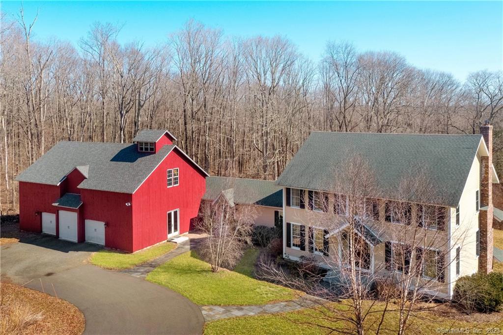 Country estate setting within the seaside town of Madison, Ct This custom-built home mirrors the classic New England home but with all the modern amenities, classic red barn, private grounds, a beautiful view, charming stone walls, and more. Architecturally designed by Duo Dickinson this unique home is situated on 6.5 acres.  4500 square feet of living space includes 4 bedrooms, 3.5 baths in the main house with an another 4, 000 sq ft post-in-beam barn/garage with 6 car-capacity. The main floor with open floor plan has a beautiful chef's kitchen, family room with floor to ceiling stone fireplace, living room and dining room.  Gorgeous 5 oak floors, custom molding detail and 9-foot ceilings. 2700 sq ft walkout basement is finished and includes a full bath and additional storage space. Take in the view with a large screened in porch with Ipe Flooring. This wonderful home is Energy Star Rated with its fully foamed insulation and heated with state-of-the-art Geothermal Heating. Property abuts Madison Land Trust woodlands. Come enjoy this truly special home. Possible equestrian property. Room for a pool.