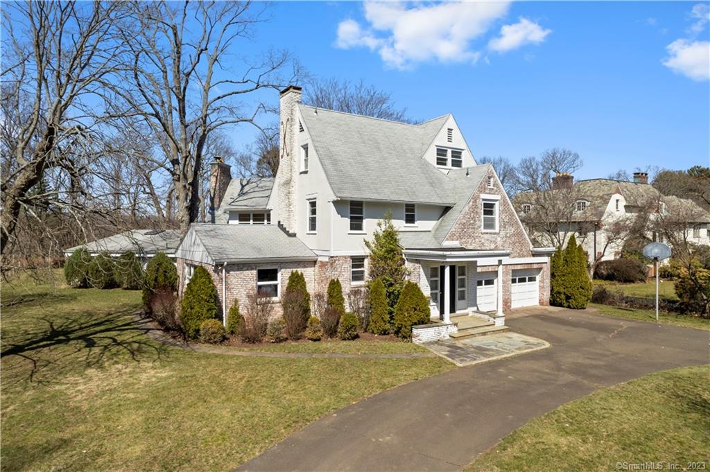 Rare opportunity to own a magnificent 5594 SQ FT brick colonial overlooking Lake Whitney sited on a picturesque .79 acre lot with mature landscaping, circular driveway, and stone patio. Located on a quiet section of Hartford Turnpike, 1 of only 5 homes with direct views of the Lake. A serene setting, yet conveniently located and a short drive to Downtown New Haven, Yale and Quinnipiac University. There is a gracious foyer for welcoming guests with a spacious half bath and large coat closet. Incredible sunken light filled formal living room with exposed wood beams and wood burning fireplace. The main level of the home offers a large formal living room, a den or office with an architecturally pleasing arched ceiling, and a remodeled kitchen with granite countertops, double ovens and updated appliances. A tiled sunroom is located off of the kitchen which leads to an indoor pavilion with a 20 x 40 ft pool. The pool pavilion has arched wood ceilings with potential to be remodeled into an in-law, library, play space, or family room. The second floor features a sun-drenched primary suite with a private bathroom and glorious views of Lake Whitney. Four additional bedrooms, two full baths, and an office complete the second floor. The third floor has one additional bedroom and bath, plus a kitchenette and bonus room - perfect for artist studio, rec room or guest/au pair quarters. Don't miss out on this distinctive home in a prime location!