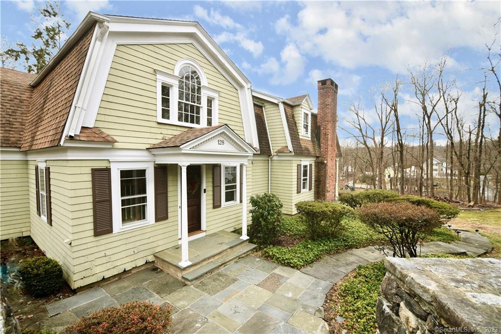 Privacy, elegance, and convenience abound in this nearly 3, 900-square-foot 3-bedroom, 3.5-bath shingle-style home. It sits in a private setting surrounded by a scrim of tall trees on a 0.74-acre professionally landscaped property just one mile from downtown New Canaan's shops, boutiques, and restaurants, and the Metro North train station. Easy access to the Merritt Parkway only 3 miles away. The chef's kitchen with granite counters and high-end appliances, including a built-in wine chiller in the center island, opens to the family room, where sliding glass doors access the deck. Fireplaces are found in the formal living room, family room, and the finished walk-out basement where doors lead to the bluestone patio and stone walls. The spacious primary bedroom suite has several closets and built-ins. Two more sizable bedrooms share a hall bath. A third full bath is located on the lower level. A custom staircase in the formal entranceway sets the tone for this elegant, yet comfortable home. This home also enjoys proximity to the New Canaan Nature Center, the Country Club of New Canaan, a playground, a tot lot, and several municipal parks.