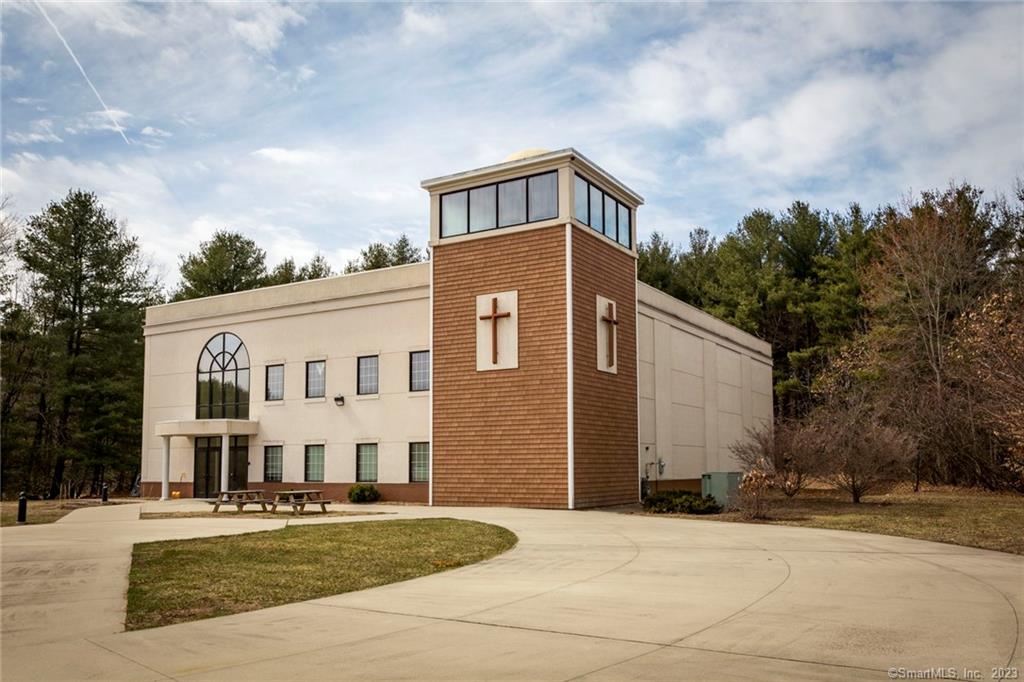 This is a rare gem! Built on almost 8 acres, this 8464 square foot building was supposed to be one of multiple buildings envisioned on this site. There is plenty of room to expand and add other buildings or a second floor (under 3, 000 sq ft could be added without an elevator). The wooded portion of the lot can be additional parking. Currently there are 2 multiple stall bathrooms, a kids bathroom, classrooms, office, sanctuary, and a small kitchen that has room for expansion. The I-291 overlay does allow other uses in this zone.