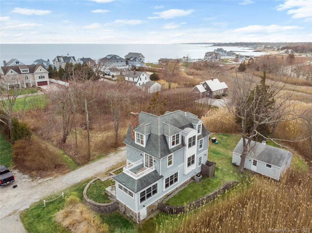 Indulge yourself in Beach Life all year long! This Architect designed Nantucket style Colonial was completely rebuilt in 2012 and features Water Views from every room, picturesque views of the golf course, a private location and stylish interior. Just steps to the beach where you can walk for miles, watch fireworks and witness breathtaking sunrises & sunsets. It is located on a private road, just 2 blocks from the Madison Beach Hotel water front where you can enjoy drinks & dinner on the waterfront veranda. This young home was built with an open concept floor plan, gourmet kitchen, sun drenched rooms and family room with wood fireplace. 2nd floor features 2 bedrooms, full bath & private deck. On the upper level you will find a master bedroom and newly constructed, luxurious master bathroom. Living room French doors lead to a patio with an outdoor fireplace and shower. Great for entertaining! New high efficiency boiler. A finished garage with skylight can be used for bikes, kayaks, a car or even an artist's space. Continue down a quaint path leading to the private beach. This home has deeded beach rights! Conveniently located near one of Connecticut's most charming town centers and Shoreline East Train Station. This is more than a home. This is a lifestyle of sea breezes, sand, and water views. Ask about Physician's loans with very little down. Hurry, won't last!