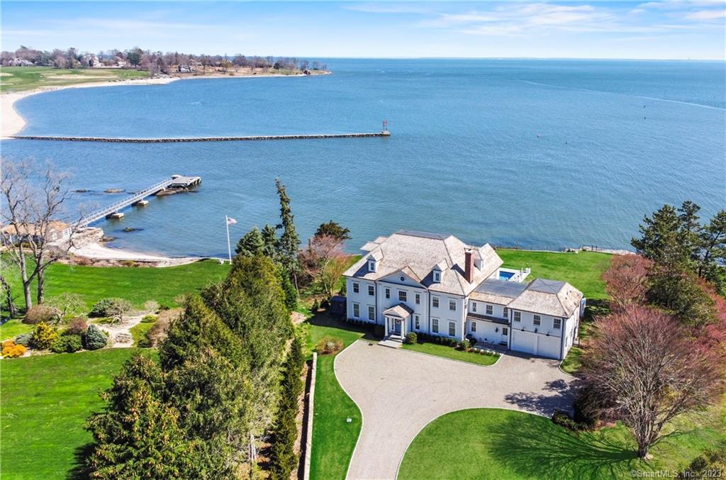 Welcome to 1093 Pequot Avenue - selected amongst all mansions in the nation and highlighted on an episode of Fox Business Mansion Global for its magnificence and beauty. Southport's Premier 2 year young home is set on a level full acre of direct waterfront w/ unobstructed panoramic views of Southport Harbor & Long Island Sound. Brilliant architecture coupled with the highest level of craftsmanship add to the allure of this estate. Abundant natural sunlight throughout the first floor w/ the wall of glass doors that span the width of home provide a landscape of breath taking water views. This modern day floor plan spared no expense w/ custom high end finishes, lighting, window treatments, mill work, and impressive details. Three levels of living, 9000+ SF, 17 spacious Rooms, 6 full and 2 half Baths, 5 en-suite Bedrooms including the Primary with a Sitting Room, his/her walk-in closets, and private Deck overlooking the water, 2 car Garage with 2 car lifts that services a total of 4 cars, 2000+SF unfinished lower level (not often found in water front homes ideal for storage) & whole house generator. The back yard features multiple Patios/Terraces and seating areas that surround your salt water Gunite pool with sparkling water views. Spend your days watching the boating activity from the Harbor, wake up to amazing sunrises and sip coffee from your balcony and enjoy all this resort-like lifestyle truly offers. Minutes to Southport Beach, Village, Harbor, Train and Library.
