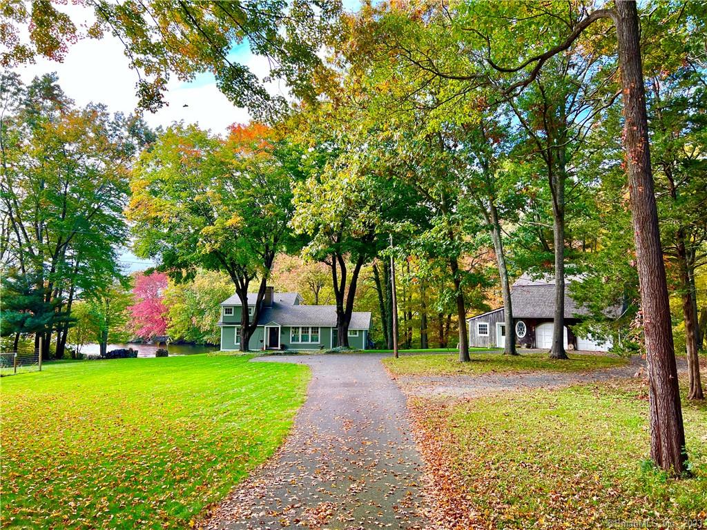 Discover 265 pristine acres to row, boat, fish and swim at your doorstep. This reimagined lakeside cottage is an idyllic retreat. A combination of open lofted spaces and intricate details evoke a rustic sophistication punctuated by stunning views. Grain fir floors, locally quarried stone, a gas fireplace, beamed ceilings and window seat enhance spaces crafted for multiple uses. A sun-filled kitchen has gas cooking and incredible storage. The great room offers dedicated dining and seating areas. A first-floor bedroom features exposed stone. The mudroom/laundry/office and a full bath complete this level. A turned stair leads to the primary suite with views. The main house is an efficient 1507 SF, and the post & beam barn, just 20 steps away, offers tremendous additional living space on two floors - a first floor studio and upper level guest quarters with kitchenette and full bath. There is a 2- bay garage with a large storage area. Both buildings are completely renovated (see spec sheets)  both infrastructure/embellishments: well, septic, wiring, plumbing, Marvin windows/doors, HE propane heating, on demand hot water and central air. Sited on one of the largest lakefront parcels, find 1.49 acres (n an R-10, .25 acre zone,  plenty of room to enjoy and retain a sense of privacy. The property is 2 miles to Old Lyme village galleries, shops and schools and a world away. If you're not yet convinced return for the sunset. Welcome home.