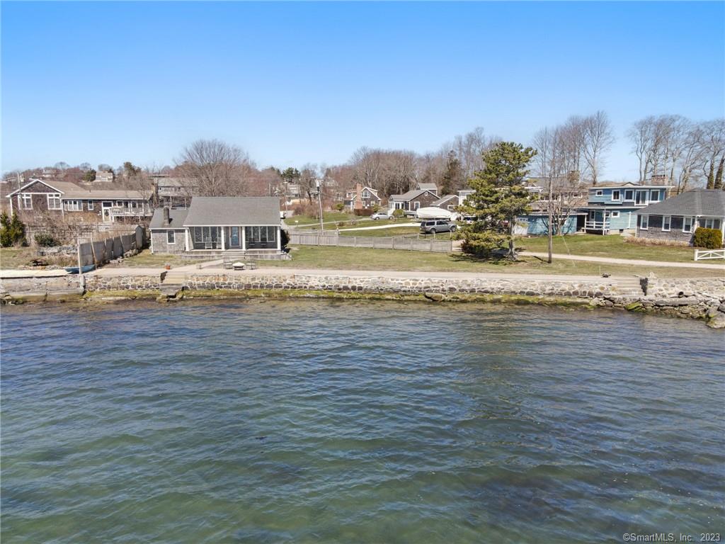 Breathtaking 115 ft Direct Waterfront Property with unobstructed views of Fisher's Island Sound! Home features an open floor plan, 2 bedrooms, 1 bath, covered deck with amazing views of the L.I Sound, renovated 1992, double lot, 1 car garage and restored seawall. Seller obtained a variance to construct a second story and Buyer is responsible for pulling all municipal permits.