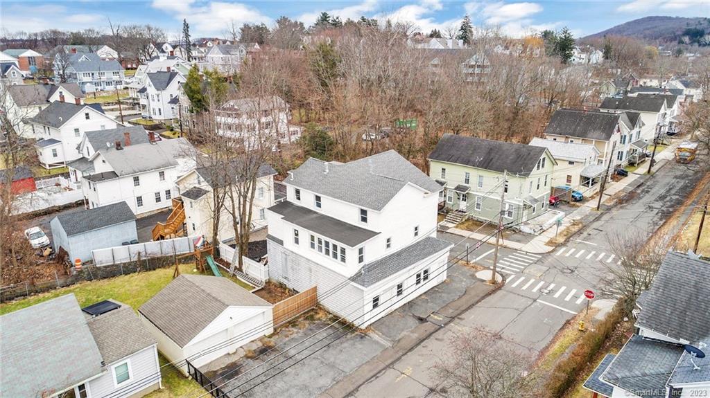 Have you been seeking a centrally located mixed-use property with two renovated residential units, ample parking, and a versatile commercial space? You're in luck! Situated in a highly sought-after area less than 1-mile from Western Connecticut State University and Downtown Danbury, this incredible property affords an array of cashflow possibilities for the seasoned investor or savvy homeowner. Currently gutted and steel-framed, the first-floor commercial unit may be further split into two units and offers a range of options for finishing. Explore the two fully renovated residential units to discover chic modern appeal. Each 3BR/1BA unit features an openly flowing floorplan, overflowing natural light, beautiful faux wood flooring, a contemporary color palette, a spacious living room, and a fully-equipped kitchen with stainless steel appliances, quartz countertops, trendy white shaker cabinets, an electric stove, a built-in microwave, a refrigerator, an attractive tile backsplash, an undermount stainless-steel sink, and a dining area. All bedrooms are wonderfully-sized with dedicated closets, while the renovated full bathroom delights with a shower/tub combo and a storage vanity. Additionally, the second-floor unit includes a flex room, which may be utilized for a home office, art studio, or a lifestyle specific need. Other features: available parking, tons of storage throughout, close to shopping, restaurants, schools, and parks, and much more!