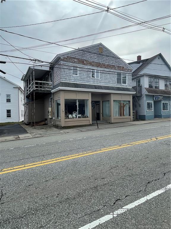 Great commercial/mixed-use opportunity in Downtown Putnam. Providence St. is the next goal of revitalization in Putnam and this building is a prime opportunity. The first floor currently has two commercial units that are retail or office space. One side has been a hair salon for many years and equipment is still in place with plumbing. Units are approx. 640 sq. ft. with open areas, 1/2-bathroom, storage and office space. The salon also has washer & dryer. The second commercial retail was a storefront sales business. These units could be combined as well as your business grows or great small offices. There is public parking across the street. Upstairs are two 1-bedroom apartments needing some TLC but very close to being rentable. Building was completely renovated in the mid-1980s so the majority of the major mechanicals are semi-modern. City water, sewer & gas.