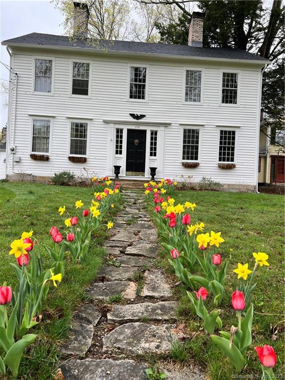 The Earl Munson Home This 18th century house is situated on the west side of Main Street near the corner of School Street. The old records show the land on which was purchased on May 12, 1769, from John Deming by Phillip Pond Sr. The house was built between 1769 and 1776 by Phillp Pond Sr. who later died that April. Abiel Linsley purchased the home from the heirs of Phillip. The house is well Preserved and is naturally situated back from the road with a sweeping front lawn. It's a white clap boarded house with two chimneys. The front entrance opens into a reception hall from which the stairs will ascend to the second floor. The present living room is at the back of the house and is composed of what was formerly the early kitchen and old sink room. There are two fireplaces in each chimney and in the large fireplace it has a Dutch oven. To the right of the hall is the dining room with fireplace, and a borning room, now made into a kitchen. A smaller front room is to the left of the hall. The entire house is furnished with interesting and appropriate antiques.