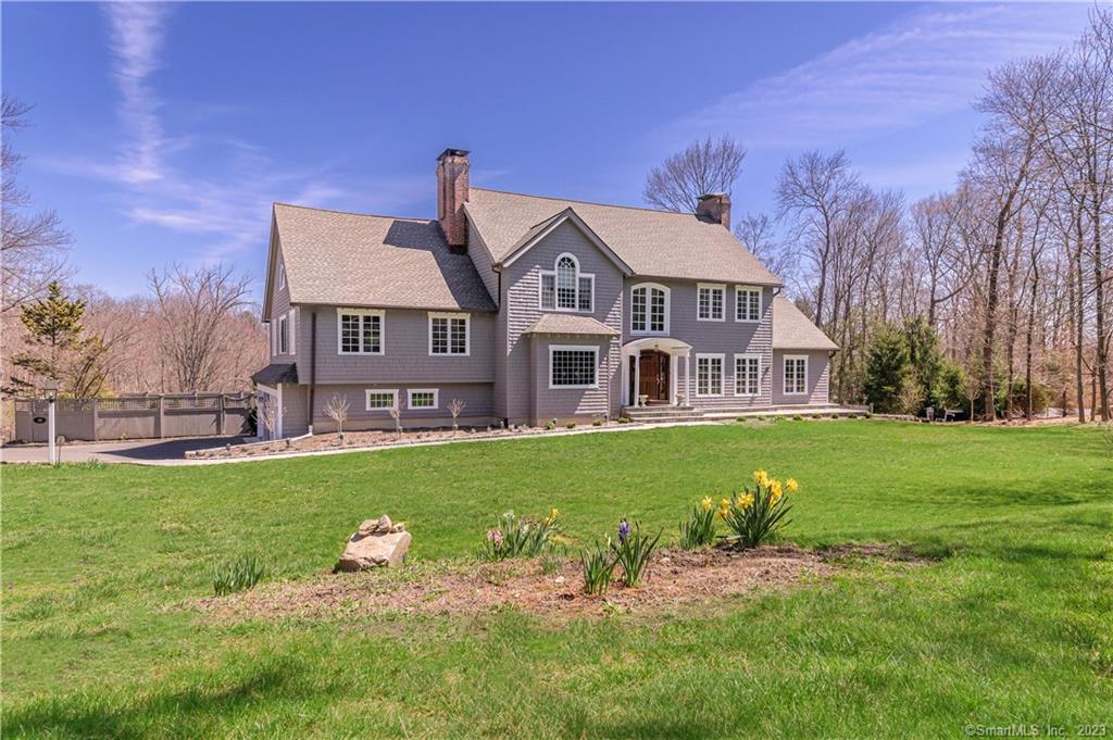 Walk to Ridgefield's vibrant downtown from this extraordinary 5 bdrm English Colonial offering timeless elegance with modern luxury. As you enter the home you'll be greeted by a sweeping staircase and gleaming HW floors. The elegant Living Rm is sun-filled featuring a FP & connects to a private office w/vaulted ceiling & FP. The spacious Dining Rm w/FP is perfect for dinner parties & special occasions. The fabulous gourmet Kitchen is truly the heart of the home w/marble counters, center island, SS appliances & Wolf 6-burner range perfectly positioned to overlook the backyard and pool. The Kitchen has direct access to the impressive Family Rm w/vaulted ceiling & FP. A main floor Bedroom with full bath creates an ideal guest or au pair suite. Laundry, Mudroom & Powder Rm complete the main level. A luxurious Primary Suite incl a vaulted ceiling FP & walk-in closet. 3 Add'l BBR's are spacious & offer plenty of natural light. Workout or just kick back in the partially finished LL offering rec space & wine cellar. Outdoor spaces are equally impressive w/lush landscaping, expansive deck + patio & heated pool creating the perfect spot for summer fun. Peace-of-mind amenities - are the 3-car garage, newer windows, furnace, security system, C/A, & abundant storage. Convenient to the Katonah Train Shuttle, shopping, premier restaurants & Ridgefield's #1 cultural district. Approx. 1hr to NYC.