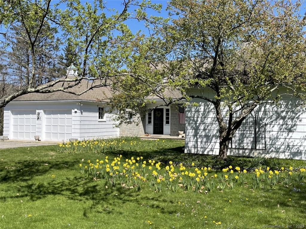 Welcome home to this French Country Ranch within walking distance to Historic Downtown Woodbury Connecticut. This lovely 1950's home has been exceptionally maintained. Natural beauty surrounds this home through every window year round. The gardens and meadow are filled with a profusion of colorful, fragrant perennials and wildflowers. The 4 rolling and wooded acres offer 3 large paddocks, a horse barn, gardens & fruit trees. The perfect home for entertaining friends and family. Enter this charming home through the dutch door & you will feel right at home, natural light fills every room. The chef's eat-in kitchen is enriched with incredible cabinetry, Viking gas range, wine cooler, a marble farmhouse sink and soapstone counters. The living and dining areas are embellished with gleaming hardwood floors, crown moldings, fireplace with propane insert and numerous built-ins. The 2.5 bathrooms have been recently updated while maintaining the original character. The en-suite primary bedroom offers 4 closets with plenty of storage. Two additional bedrooms on the main level share a jack and jill bath. The sunroom offers the most beautiful views of the meadow, barn and sunrises. As an extra bonus, the upper level has a 28' x 17' family room with a propane fireplace insert & built-ins. Whether this will be your primary residence or a second home located 1.5 hrs from NYC, make your appointment today and begin to enjoy the New England country lifestyle in Litchfield County!