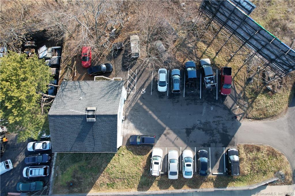 Currently being used as auto repair. Has two lifts and 4 office/rooms upstairs. 12 off street paved parking spots, plus two counting bays.