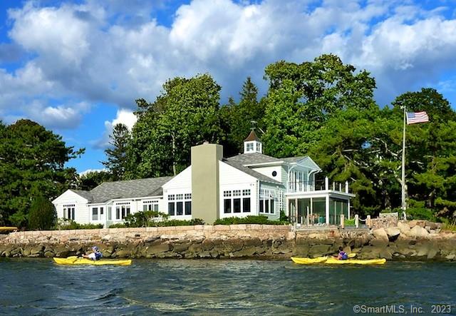 Ideally located in the picturesque village of Stony Creek in the town of Branford, this elegant and secluded home features magnificent views of the Thimble Islands and Long Island Sound. With direct waterfront at harbor's edge, the 3100 square foot house graciously accommodates six--with three en suite bedrooms (two are suites, one with adjoining sitting room and cafe bar, one with office). The spacious two-story living room with fireplace, dining room, family room, kitchen and bedrooms all have spectacular water views. The south-facing screened porch accesses the large garden terrace and 30-foot pier (sea depth at high tide: 6 feet; mooring available). Amenities include a laundry room, wireless internet and ample courtyard parking. Stony Creek is 12 miles east of New Haven and 75 miles from New York City. It's minutes away from beaches, boat tours, scenic village greens, historic homes, quaint shops, nature walks, casual and fine dining and vibrant cultural life. Available August 19-October 1--two-week minimum rental; $1000/day. $200/week cleaning fee.