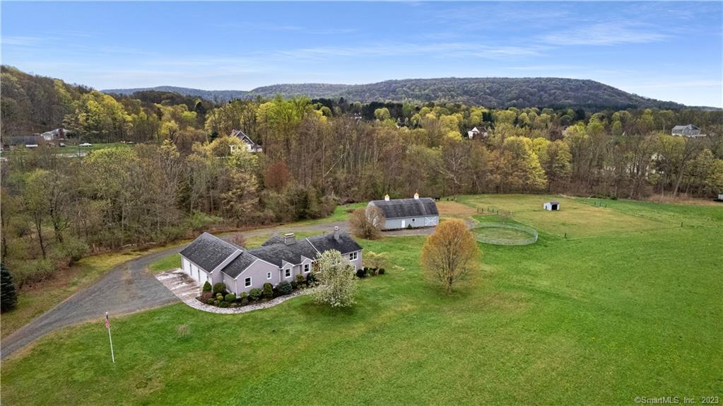 Welcome home to your dream equestrian estate in picturesque Durham, Connecticut! This stunning, turn-key horse property offers the perfect combination of luxurious living and equestrian amenities, all nestled on over 7 acres of pristine land, bordered by mature trees. Inside the main house, you'll find an updated living space that boasts hardwood floors, vaulted ceilings, and ample natural light. A gorgeous dual aspect fireplace, and sunny open plan create a relaxed elegance. The chef's kitchen features top-of-the-line stainless appliances, granite countertops, indoor grill, tile backsplash, rangehood fan and breakfast bar, perfect for entertaining. Your primary suite is a true oasis, with a large walk-in closet, spa-like bathroom, and tiled hot tub room featuring a brick fireplace and stunning views of the property. Outside, your beautiful 2 story barn comes complete with 240 amp service, steel beam, hoist, floor drains and propane gas line. The horse/livestock area has nelson water bowls, tack room, grain room, inside bedding storage stall and a large sliding exterior door for easy delivery. The barn is fully equipped with everything you need to care for your horses, and ample storage for hay and equipment. Offering the perfect blend of natural beauty, modern convenience, and timeless New England charm, you must see this unique and remarkable property to believe it; schedule your showing today!