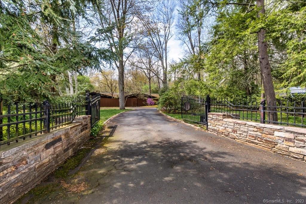 Rare find- You'll feel at home the minute you drive up this front gated, circular drive with stone walls to this beautiful custom built mid century 5, 000 sq ft home, designed by world renowned architect Cliff May, situated in fantastic neighborhood on 2.5 acres. Enjoy the benefits of an open floor plan w/ generously sized rooms, 4 fireplaces, cathedral ceilings, skylights allowing natural light to pour in, and custom architectural features/details in every room. The indoors and outdoors seem to be one w/ floor to ceiling windows, multiple courtyards, sprawling grounds offering privacy while you enjoy the serenity and views of mature specimen trees/plants chosen by landscape architect, Thomas Church. Entertain guests in the great room featuring FP, wet bar, view of indoor heated pool, large eating area, seating areas, and expansive views of the outdoors. The indoor heated pool centers the home with full length skylight and glass sliders all around. An expansive kitchen boasts another FP, large eating area, indoor grill, pantry, sliders to courtyard, marble floors, island and skylights. Built ins and yet another FP make the den/home office a great space for smaller gathering of family or friends. Unwind in your Primary Suite w/ FP, views to the outdoors and large custom bath featuring carrara marble, travertine stone floors, two vanities, oversized shower, tub, wall of closets for storage. Great location- walk to WH Center, Blue back or Bishops Corner and much more.