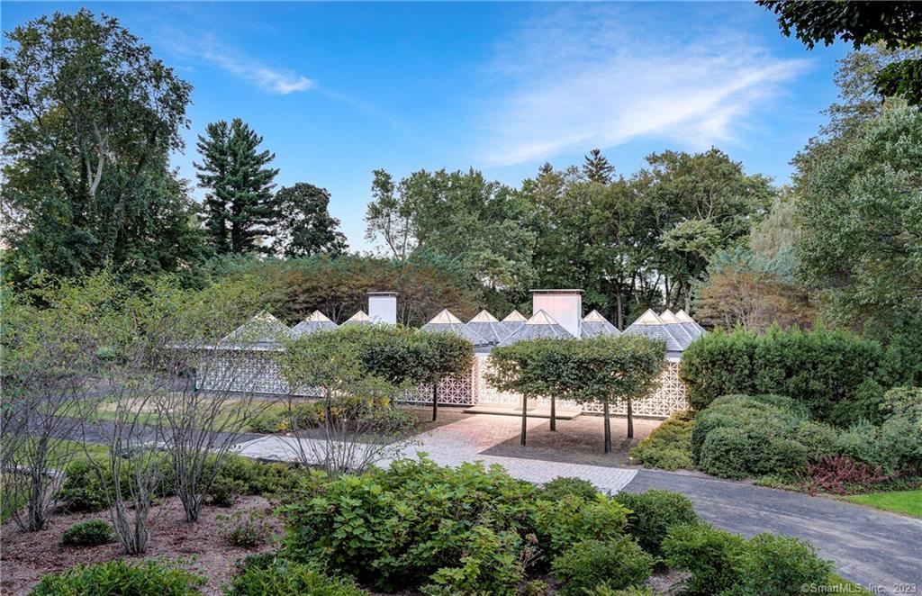 The Celanese House, by famed architect Edward Durell Stone, is a stunning example of mid-century modern architecture that seamlessly blends form and function. The house features a lattice screen on the facade and glass pyramids on the roof which are prime examples of Stone's design and, true to Stone's principles, the house is substantial, private and comfortable. Built in 1959, the house has been fully renovated, staying true to its original vision, with satin bleached oak floors and walls of glass. Natural light flows into the interior space. Visitors are greeted with an underlit glass floor at the entryway. Kitchen by Bulthaup including Gaggenau 5-burner gas cooktop, Subzero and Wolf appliances and new flat skylight. Primary Suite complete with Dornbracht bath and faucet fittings and Boffi shower pipe. Situated on two+ park-like acres, on prestigious Oenoke Ridge, with integrated landscape design to complement the structure. ...A unique opportunity to own a true masterpiece.