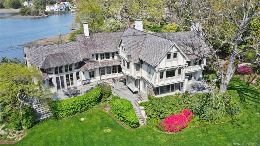 Spectacular water views abound! One truly feels they are on a luxurious yacht when looking out to the surrounding water vistas from this property. This gracious Tudor style home originally built in 1902 was extensively remodeled in 2004. Located in the private Tokeneke Association, Within an hour of the New York City, 8 Butlers Island Rd offers direct frontage on the Long Island Sound, a large private sandy beach and sweeping views of the Sound to the South. North facing rooms overlook a tidal estuary with abundant wildlife and down Butlers Island Creek all the way to the Five Mile River and Rowayton. Expansive patios overlook the beautifully landscaped backyard with a sweeping flat lawn and stone walls, which leads to the private beach and LI Sound beyond. Beach parties, pre game pasta dinners, tented birthday celebrations, clam bakes; the possibilities for entertaining groups large and small abound, or simply enjoy the water views with your morning coffee from one of the many outdoor terraces. This 5 bedroom home has been lovingly cared for, interior features include custom millwork, 9' coffered ceilings, wood paneled library, chefs kitchen and an oversized family room with a vaulted ceiling, fireplace and floor to ceiling windows. If you are looking for a truly singular waterfront property, then you should make 8 Butlers Island your destination!