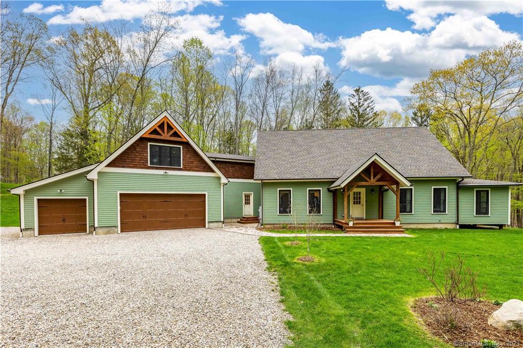 This recently completed custom post & beam cape is sited deep into the secluded 7+ acres with views of the spring fed pond and stone wall dam. The foyer opens to the great room where natural wood envelopes with a cedar cathedral ceiling. The great room includes the living, dining and kitchen which is accented by custom hickory cabinetry, granite countertops and center island. Main-level living also includes the primary suite, laundry room and half bath. Relax in the newest addition, a four seasons sun room that leads to a small deck and steps to outdoor grilling. Upstairs are two additional bedrooms, a shared full bath, and a loft that overlooks the living area below. Each of the three bedrooms has been thoughtfully wired for mounted TV's. A back hallway takes you through to the mud room and either up to the multi purpose bonus room or to the heated three car garage. Oak flooring is throughout the main house, interior doors and moldings are all Danish oiled solid pine wood. The landscape includes new plantings with a mature treescape surrounding the home. A newly built barn completes the outdoor features with a second floor, perfect for an artist studio or storage. Close to hiking trails and mins from the shops and restaurants of Woodbury, a 90 drive from NYC.