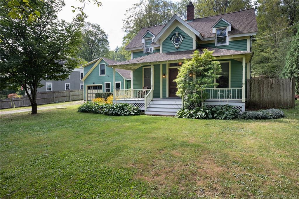 Charming Victorian with beautiful perennial gardens and stone walls abutting Church Hill in North Canaan.  A spacious floor plan includes a remodeled eat-in kitchen with French Doors leading to a pergola covered patio, Den with 1/2 bath, Living Room with fireplace and Dining Room - both with 10 ft ceilings. Solid Chestnut Doors enter from the front porch into the Dining Room. Nice hardwood floors throughout the house.  Upstairs includes a full bath with laundry, one bedroom and two additional bedrooms on the upper landing. Formerly a two car garage, one bay has been converted into a propane heated workshop.  A Studio apartment over the garage is perfect for guests or home office. New in 2020 - roof, porch, two hot water heaters, dishwasher & fridge and all floors refinished. Furnace was replaced in 2008. All room sizes are approximate.