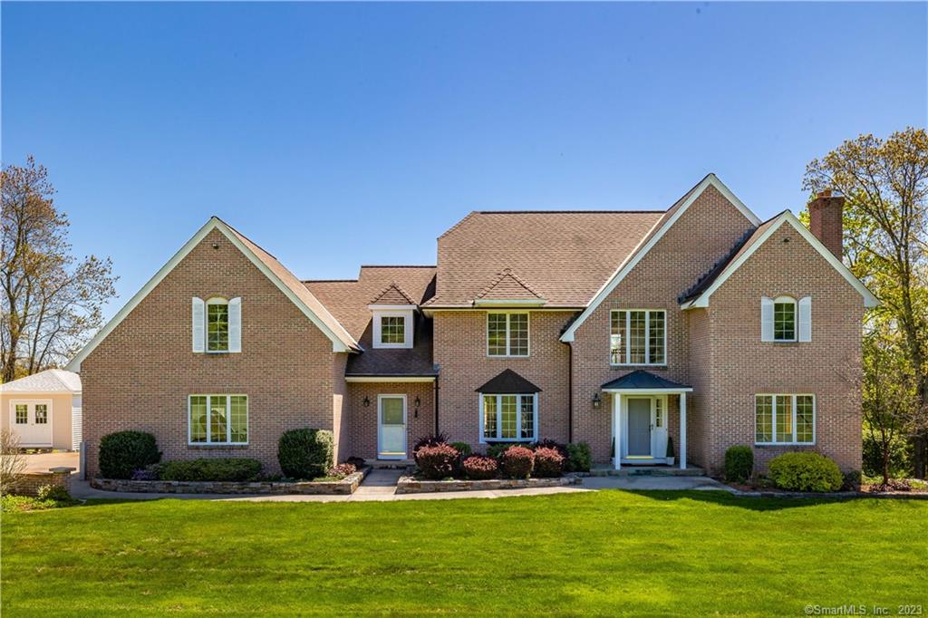 Indulge in the pinnacle of Luxury Living with this exquisite 4-bedroom custom-built Colonial on the shores of Bolton Lake. With DIRECT ACCESS and 200' frontage on the serene waters, the spectacular view is nothing short of breathtaking. This immaculate home spans 5+ acres, with 3380 SqFt of luxurious living space. Thoughtfully designed to take full advantage of the mesmerizing views. From the spacious and fully applianced eat-in Kitchen to the formal Living Room with a brick fireplace, every room is generously sized and impeccably detailed. A stunning Bay window illuminates the elegant Dining Room, while a great Den or Office space and the 15 x 23 1st floor Family Room with a Raised Hearth Stone fireplace provide ample space to relax and entertain. Ascend the double turned staircase and discover a balcony overlooking the Family Room, offering magnificent views of the lake beyond. The Primary Bedroom Suite is a true oasis, featuring not one but two walk-in closets and a private bath complete with a walk-in shower and jetted tub. Three additional, nicely sized bedrooms - including one measuring an impressive 12 x 31 - offer the ultimate in comfort and convenience. The walk-out lower level boasts a full bath and a third fireplace, providing yet another cozy space to unwind while enjoying the stunning scenery outside. Hardwood Floors and 6-panel doors add to the timeless elegance of this remarkable home, while a 2 car garage and ample storage provide ultimate convenience.