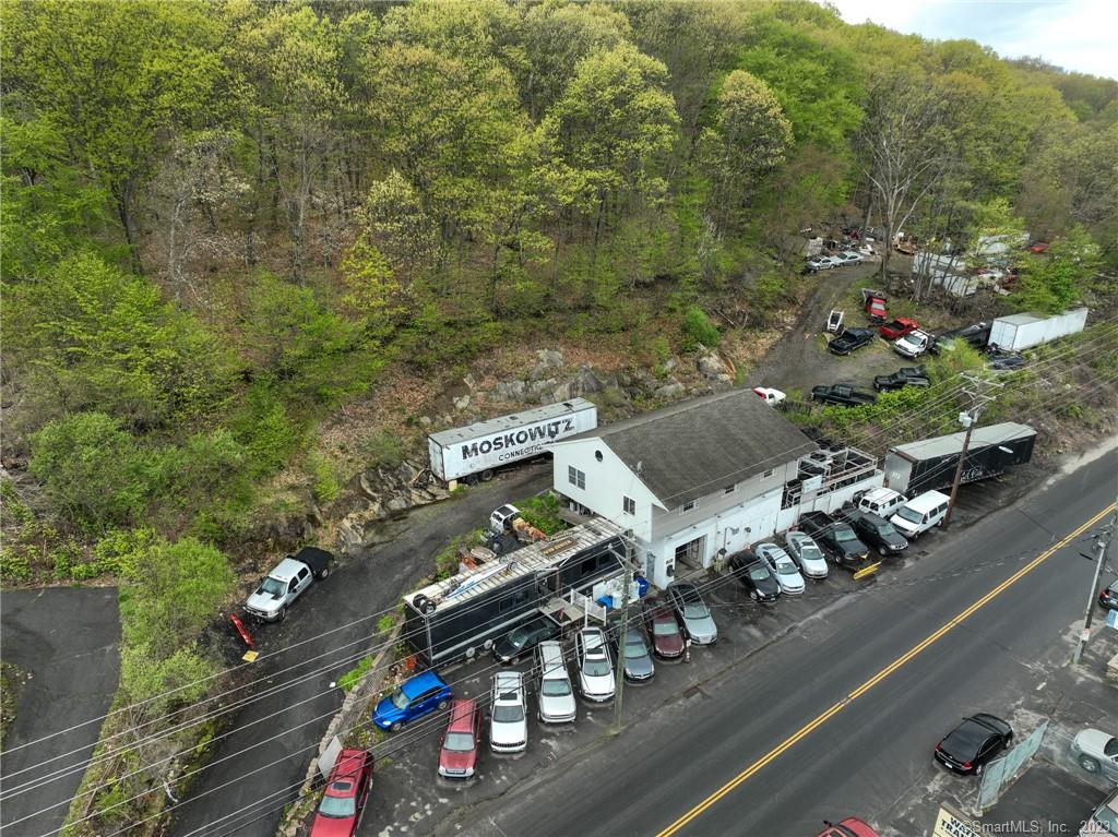 Unique opportunity to own a commercial auto building along with almost 1 acre of land on a busy commercial street with 12, 000 + cars of daily traffic for a variety of automotive business opportunities. This building was/can be used for an auto repair shop, auto sales and/or a tire shop. The property consists of 3 garages in front (1 oversized) to fit 5 cars; a private owners space above that's fully renovated w/1, 800 SF, EIK and full bath (for office, part time living space, showroom, storage). The sale also includes over $50k in equipment: 2 lifts, 2 air compressors, 2 MIG electric welders, plasma cutters, 2 wheel balancers, wheel straightening machine, tons of tools, 2 full tool chests, tires and misc. items related to auto body ++ a variety of pick up trucks, plows, trailers, SUVS, cars, and other types of automotive that convey. There are also approx.. 25 security cameras on and throughout the property that record. Sale also includes the black trailer up front on the property currently used as a show room space to meet customers. Property has a newer three-phase electric upgrade ($75k expense, approx.. 5 yrs ago) and a newer gas furnace (also 5 yrs old). WAY TOO MUCH TO LIST. If you're looking to start or expand your automotive business, this is a home-run!!