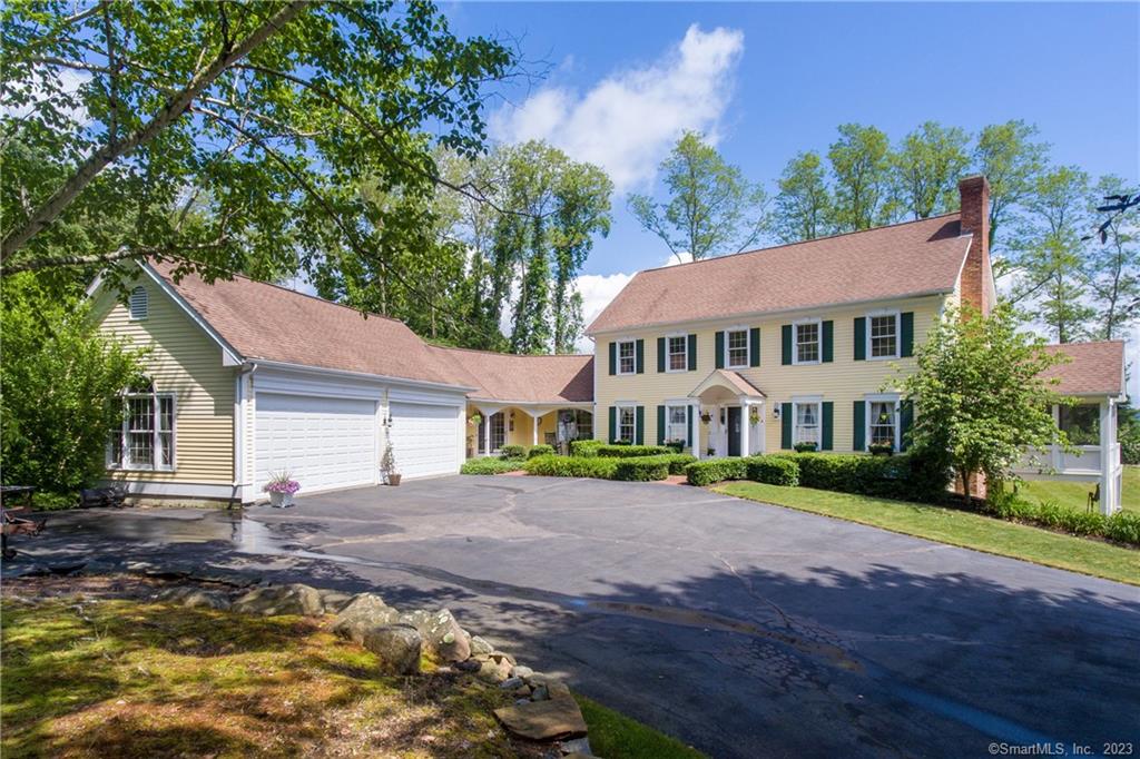 Be prepared to be surprised by the contemporary flair behind the classic colonial facade of this well-maintained home set on a private manicured 1.51-acre lot. Located in a quiet cul-de-sac neighborhood minutes from Essex village and all it has to offer, there is room for the family, guests, and an aupair or caretaker. Options here for either a first-floor or second-floor primary suite. The walk-out lower level includes a 650-square-foot apartment with one bedroom, a family room with a fireplace, a kitchenette, and a full bath. The soaring two-story vaulted ceiling and fireplace in the family room with wrap-around deck access is a joy to behold. This room perfectly complements the formal dining room and living room with a fireplace and wet bar (also open to the family room). One of the favorite spots in this house is the large second-level screened porch perched above the landscaped grounds. The spacious eat-in kitchen has a vaulted beadboard ceiling in addition to french doors leading to a serene bluestone terrace. Amenities include a four-bay garage, workshop, multiple office options, new furnace, and air conditioning systems, a long private driveway, ample parking, and glimpses of the CT River. Ample storage throughout. If quiet, privacy, and elbow room are on your wish list, wish no longer. Your next home has arrived and awaits your personal touches! Set mid-way between Boston and NYC, discover in Essex an epic lifestyle in a league of its own.