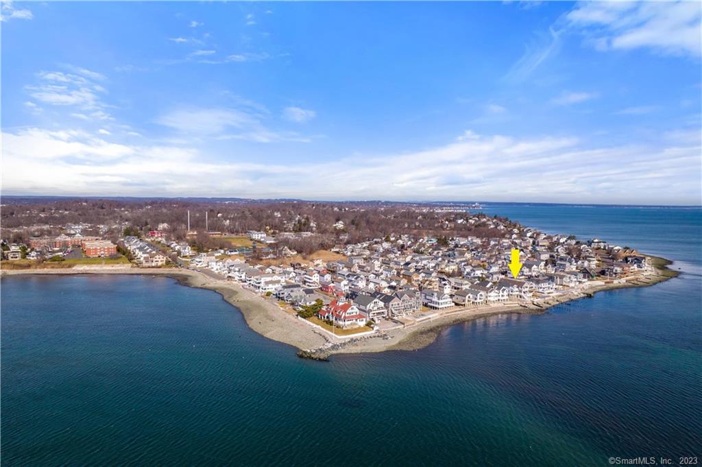 A rare opportunity to own this spectacular direct waterfront home with 180-degree water views in private, desirable Point Beach. Enjoy breathtaking sunrises and sunsets, views of Long Island Sound, and Charles Island from the multiple decks and expansive patio. The open floor plan is ideal for entertaining with its wide open Great Room that features a large Living Room with a gas fireplace, a newly updated gourmet kitchen accented with white custom cabinets, quartzite marble countertops, center island, stainless appliances including double ovens, breakfast bar, and Dining Area for your larger crowds. Hardwood flooring throughout, smart home features include LED lighting, audio/sound system, thermostats, and garage. An elevator services all living floors. A powder room and main level bedroom with custom tile full bath and sliders to balcony complete the main level. Three bedrooms on the upper level include a fabulous Master with vaulted ceiling, sliders to a private balcony, an enviable customized walk-in closet, and a spa-inspired full bath with double sinks, custom steam shower, heated floor, and jetted tub. The waterfront decks and patios will dazzle all your guests. A large waterfront covered patio is ideal for shade, bar, and buffet entertaining. Unbelievably low flood insurance is under $900 per year. This could be your summer 2023 home! Hurry, it won't last.